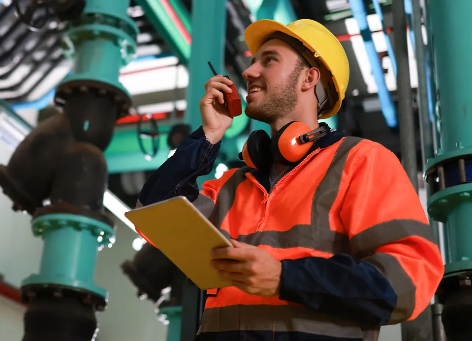 Two commercial plumbers inspecting equipment